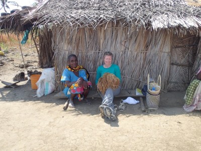 <b>Figure 2.</b> <i>Tanzanian farmer and archaeological worker Aisha shows Sarah the best rice for planting.</i> Madaweni district, Songo Mnara, Tanzania (Image Copyright: S. Walshaw).